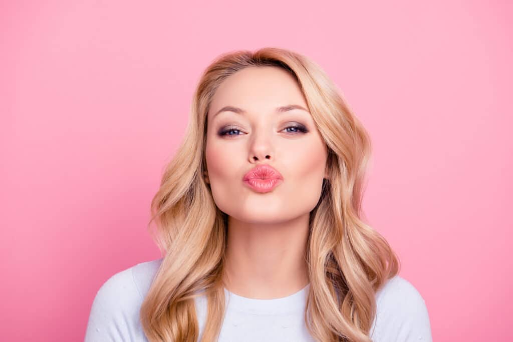 A women kissing pose | Sculpted Aesthetics in Columbia, SC