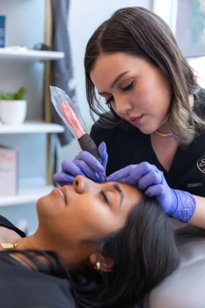 A person getting a tattoo on her face