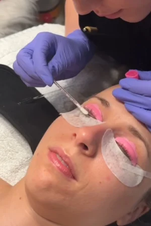 A person getting eyelash extensions done